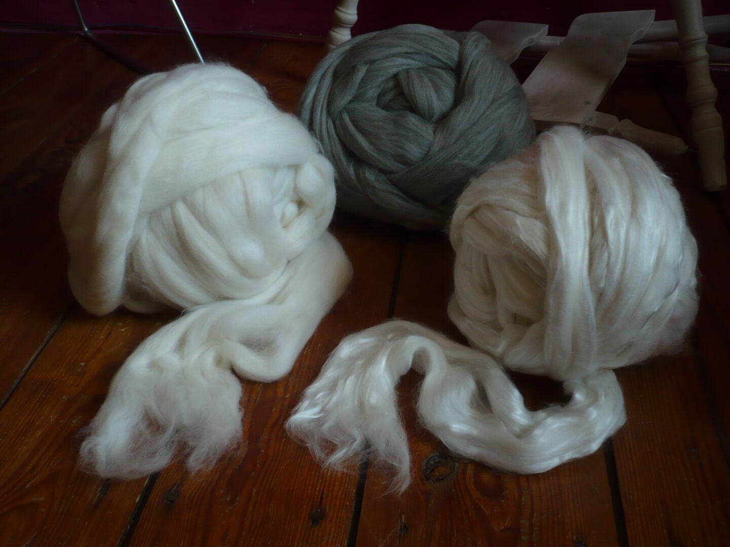 three balls of wool fibre, ~500g each