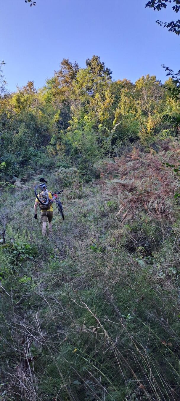 Carrying the bike uphill to find a parallel path about 100m away