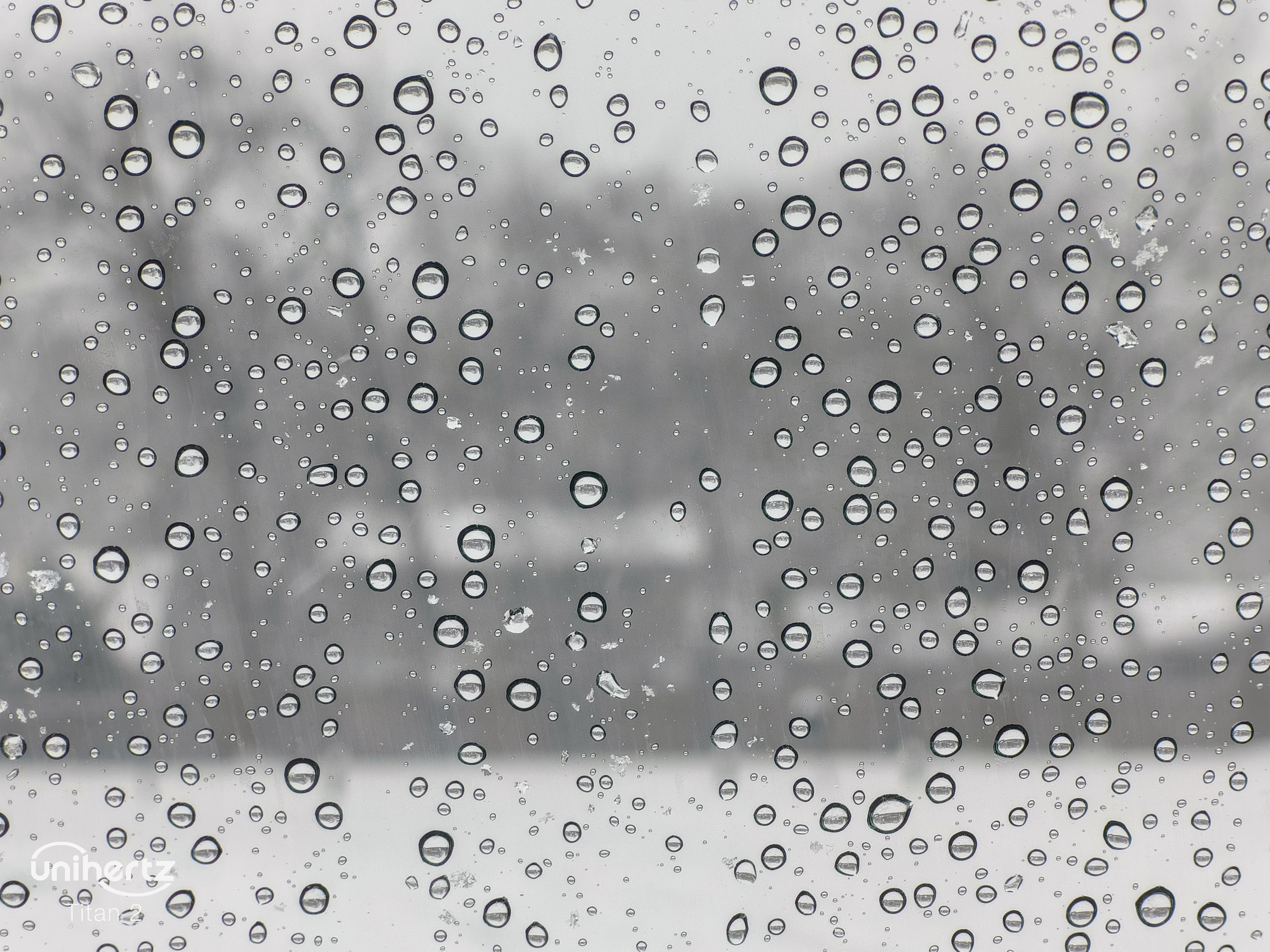 Water droplets on a card window during snow