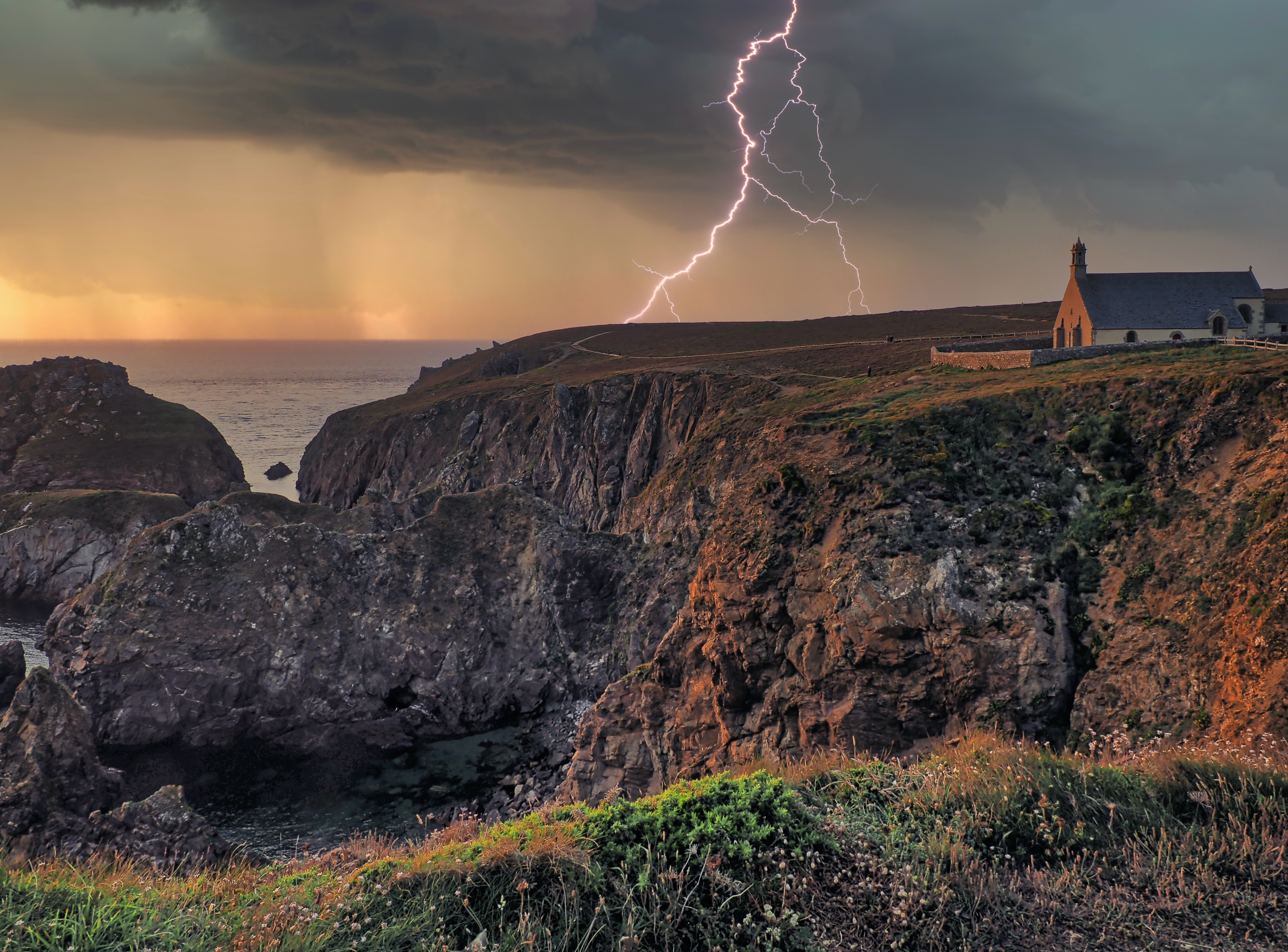St-They (Cléden), a chapel directly on the cliffs of Cape Pointe du Van, Brittany

When I want to capture both a dramatic landscape and a dramatic sky in a photo, I sometimes find it difficult to decide which part of the image to focus on. When there's lightning, it's even harder. Here, I opted for the "safe" part, the rocky coast, but I was lucky enough to just barely catch a flash of lightning.

#bretagne #finistere #baiedestrepasses #lightning #rockycoast #seascapephotography #atlanticocean #photography #omsystem