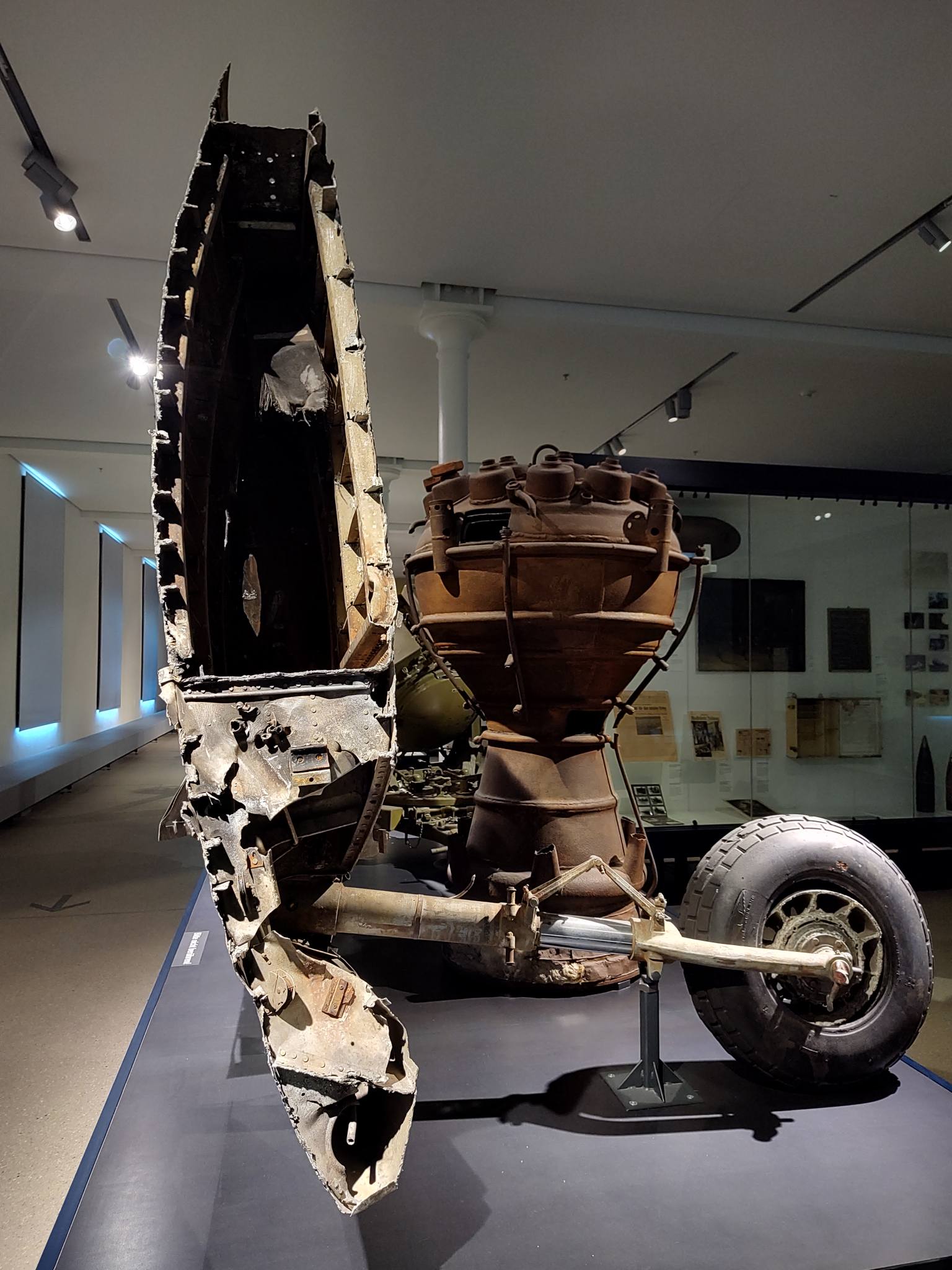 partially destroyed right wing section of a P-51D Mustang warbird, with the gear extended, on display, nose down; shot down over Germany at the end of WW2
