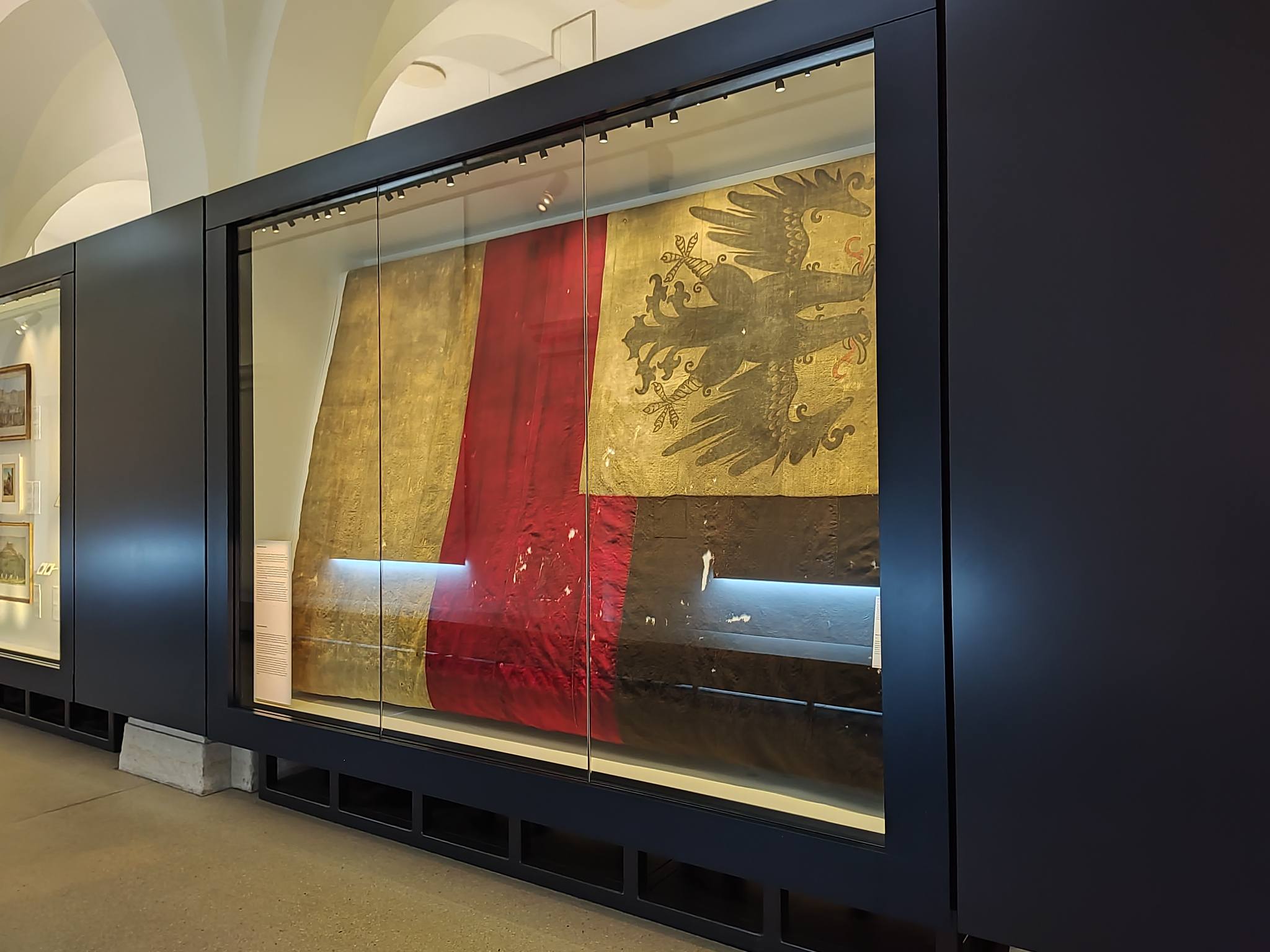 One of the first black-red-gold German flags on display, with a double-headed black eagle on a gold field in the canton; this is a Bundesmarine flag from 1848-1852, and possibly flew in front of a naval office building