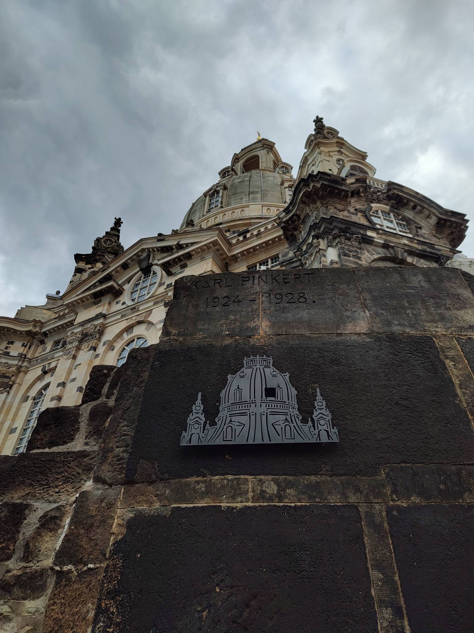 Frauenkirche seen from the ground, with a fragment of the original church in the foreground (still resting were it fell when the church collapsed in 1945)