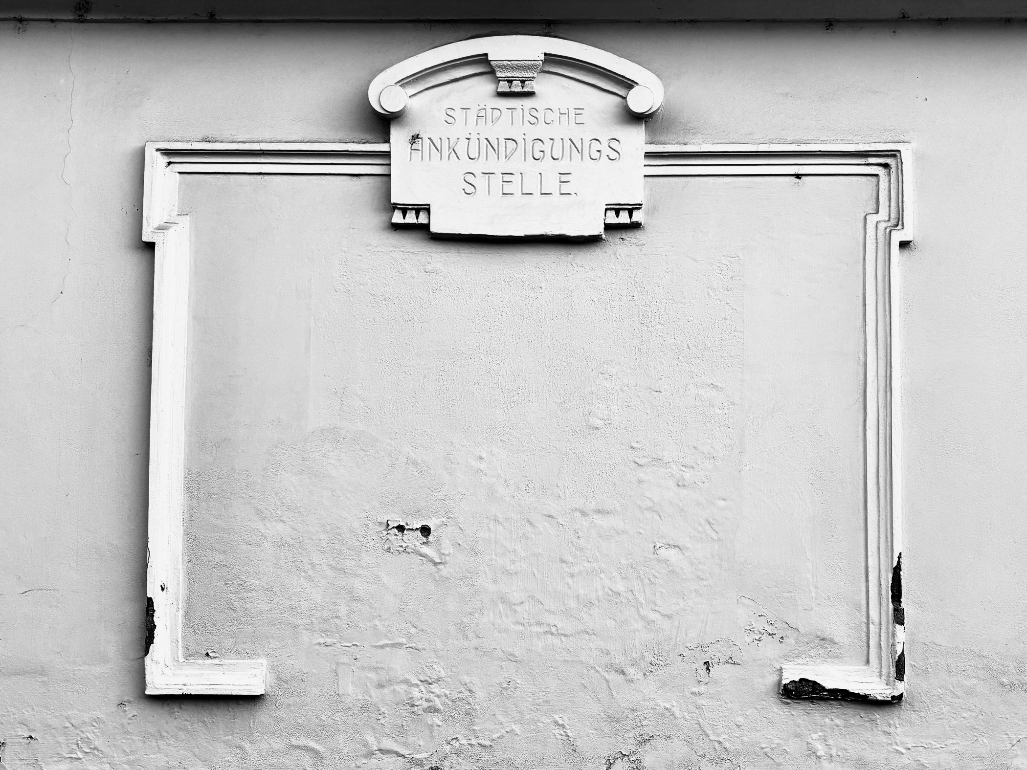 eine leere Wand mit Schäden und der entsprechenden Beschriftung