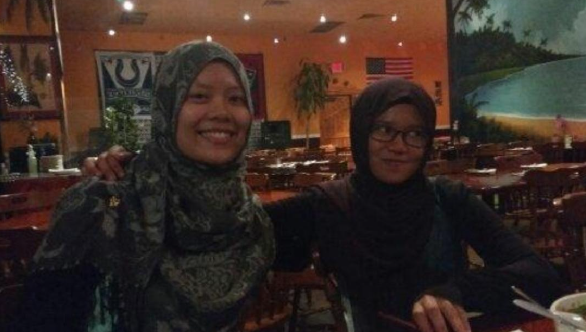 a picture of two individuals smiling before eating dinner