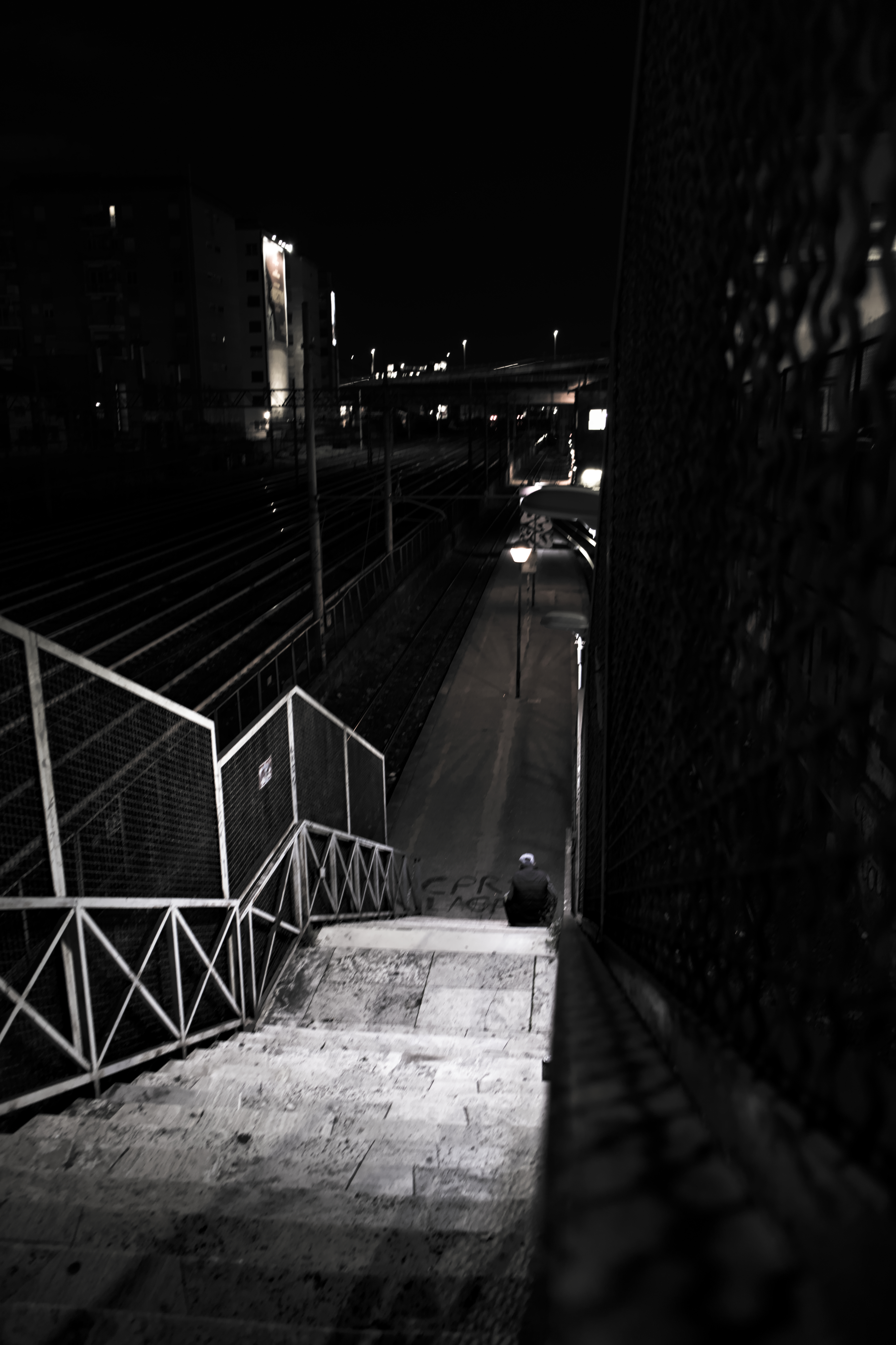 Alone man waiting for train in night